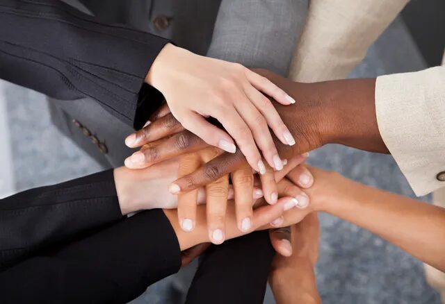 High Angle View Of Multiracial Businesspeople Stacking Hands Over Each Other